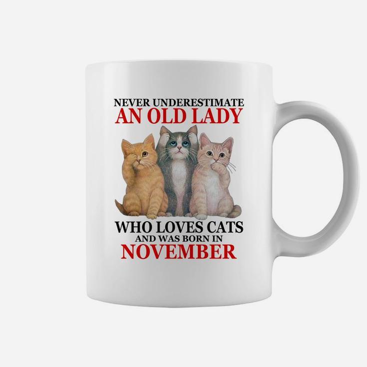 Never Underestimate An Old Lady Who Loves Cats - November Coffee Mug